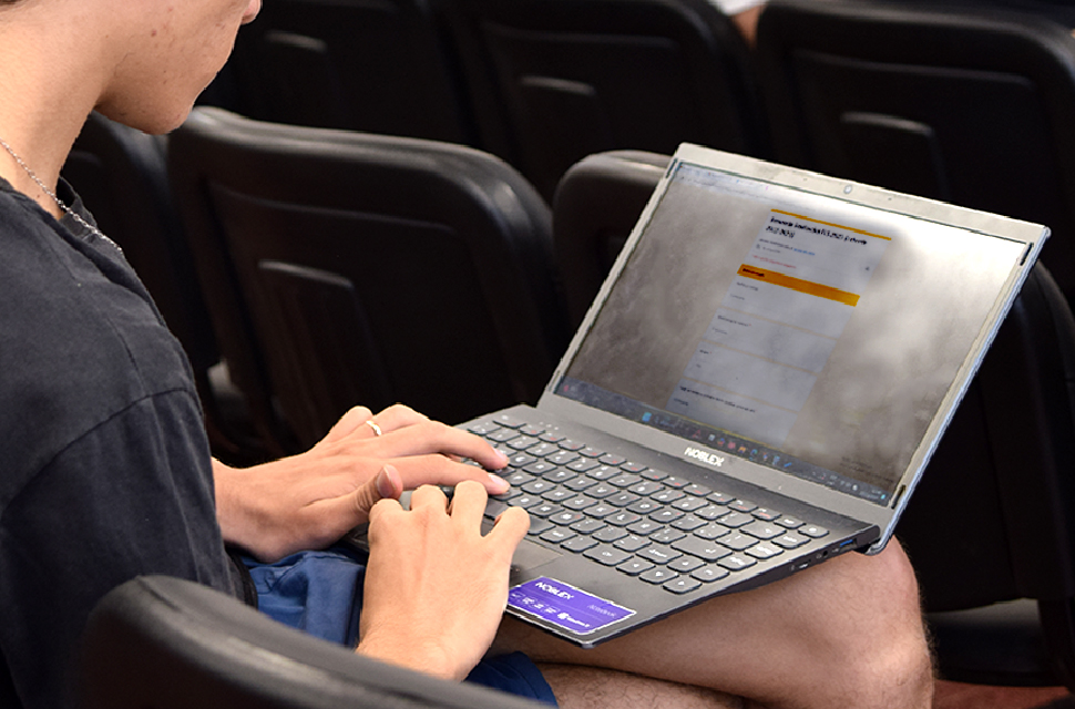 persona-con-una-notebook-contestando-la-encuesta-de-graduades-imagen-ilustrativa