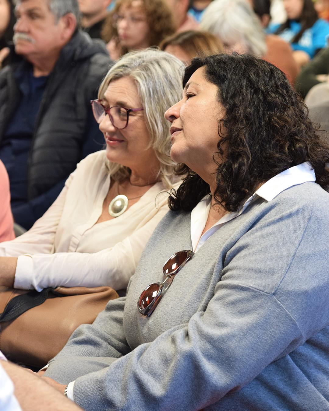 Primer plano dos personas mirando al escenario atrentamente