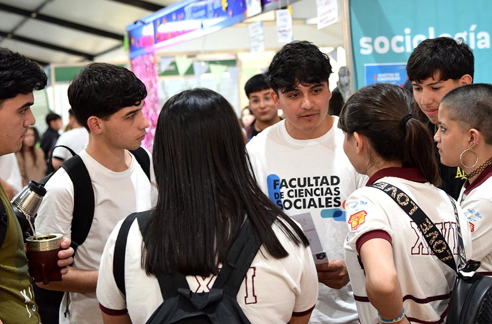 Estudiante voluntario de sociales conversando con estudiantes de secundarios